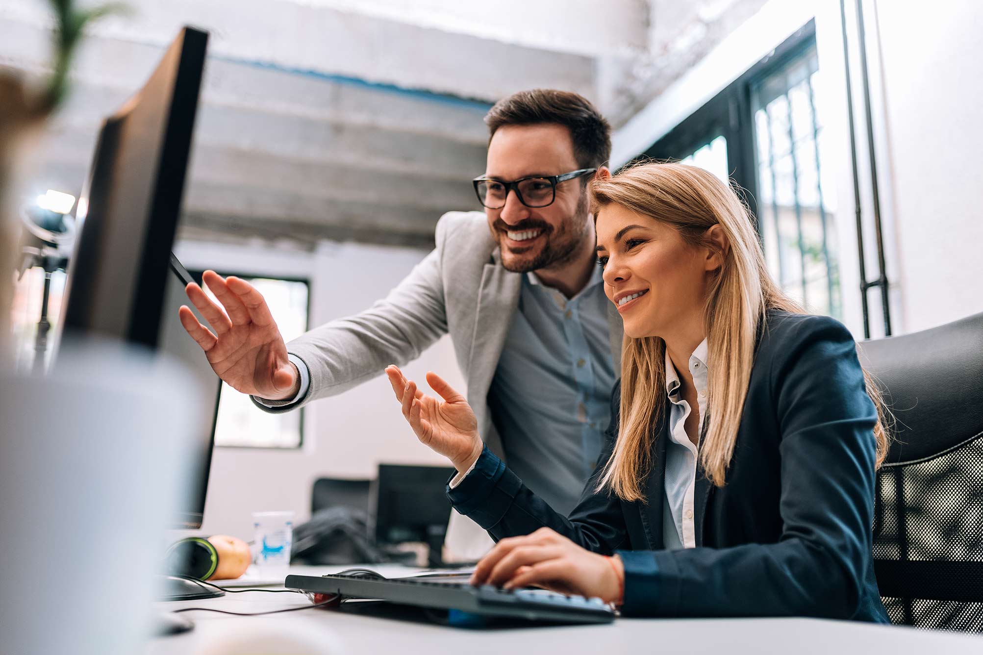 Man and women discussing in front of computer